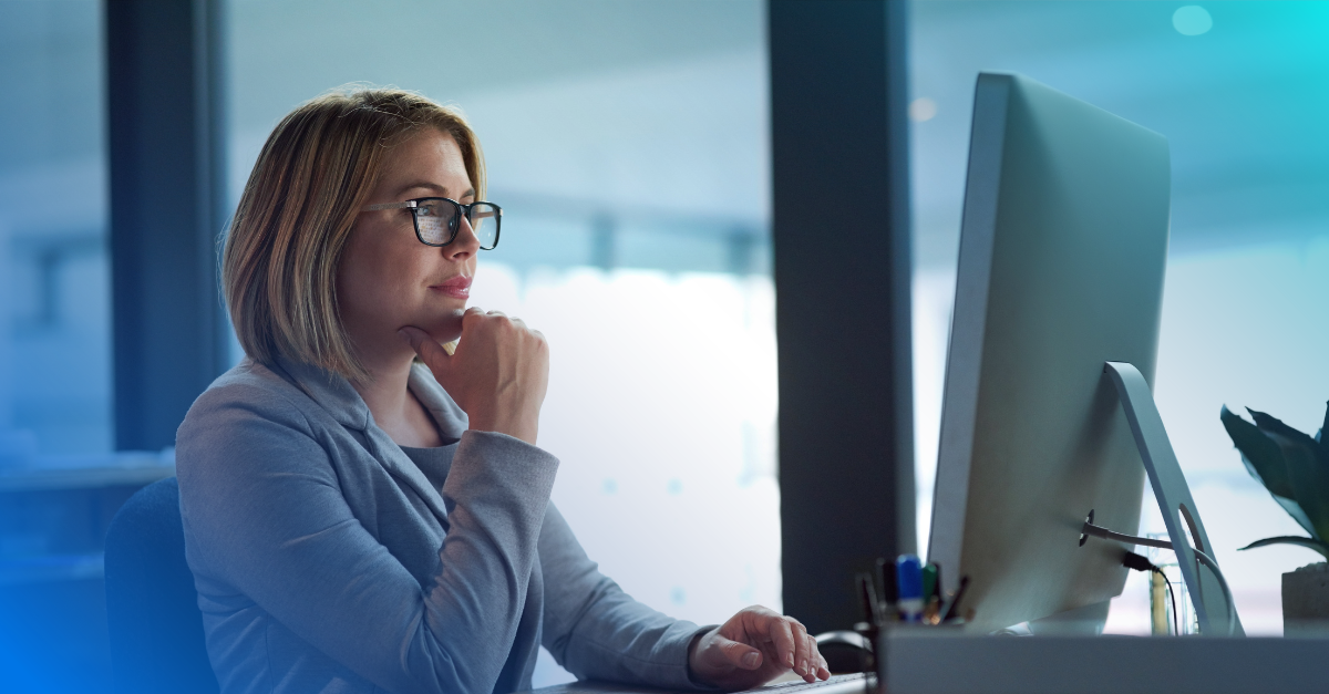 Professional woman reading information on laptop.  