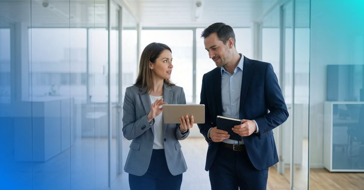 Woman and man having a conversation in an office setting.